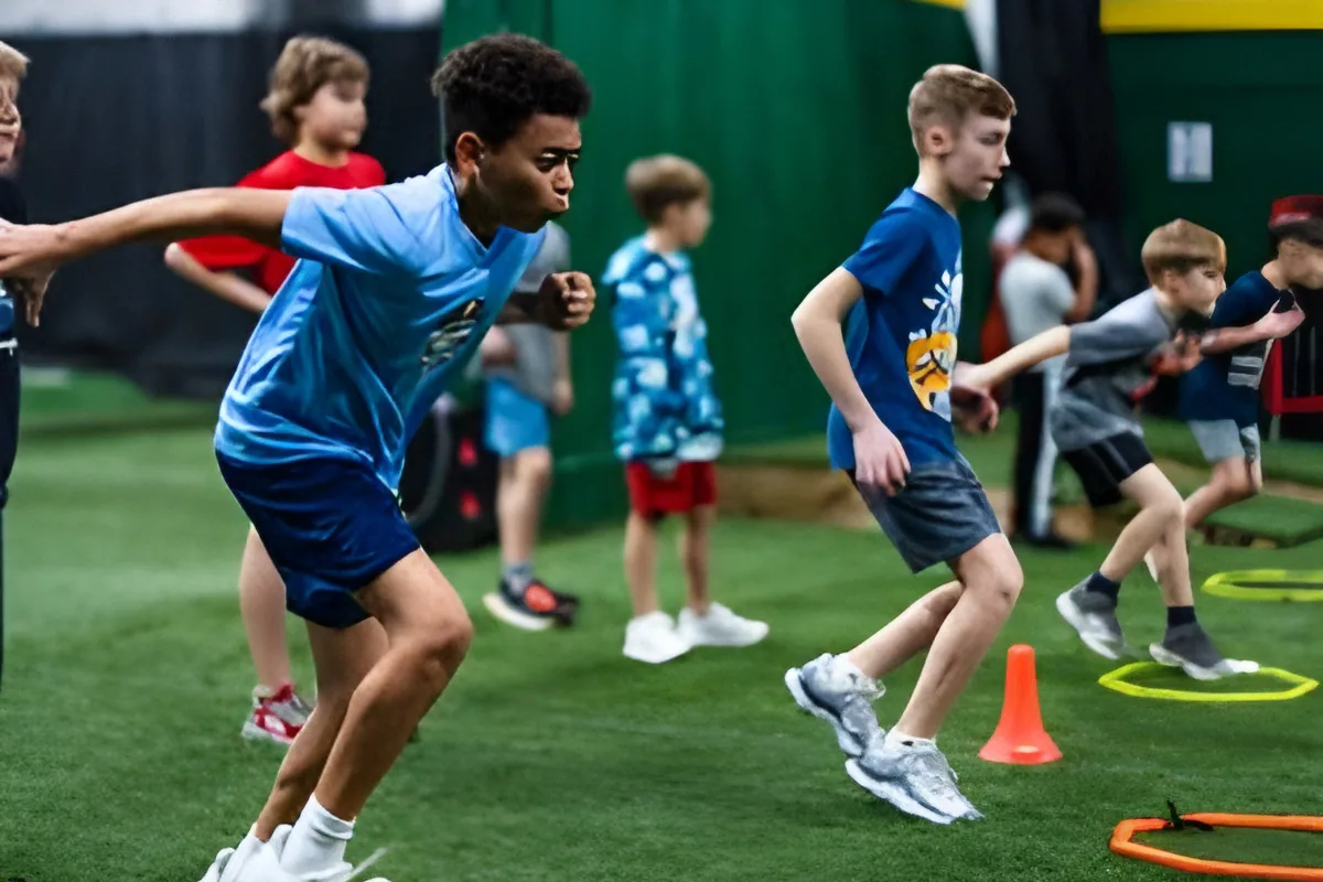 Young athletes running an agility drill through rings and cones