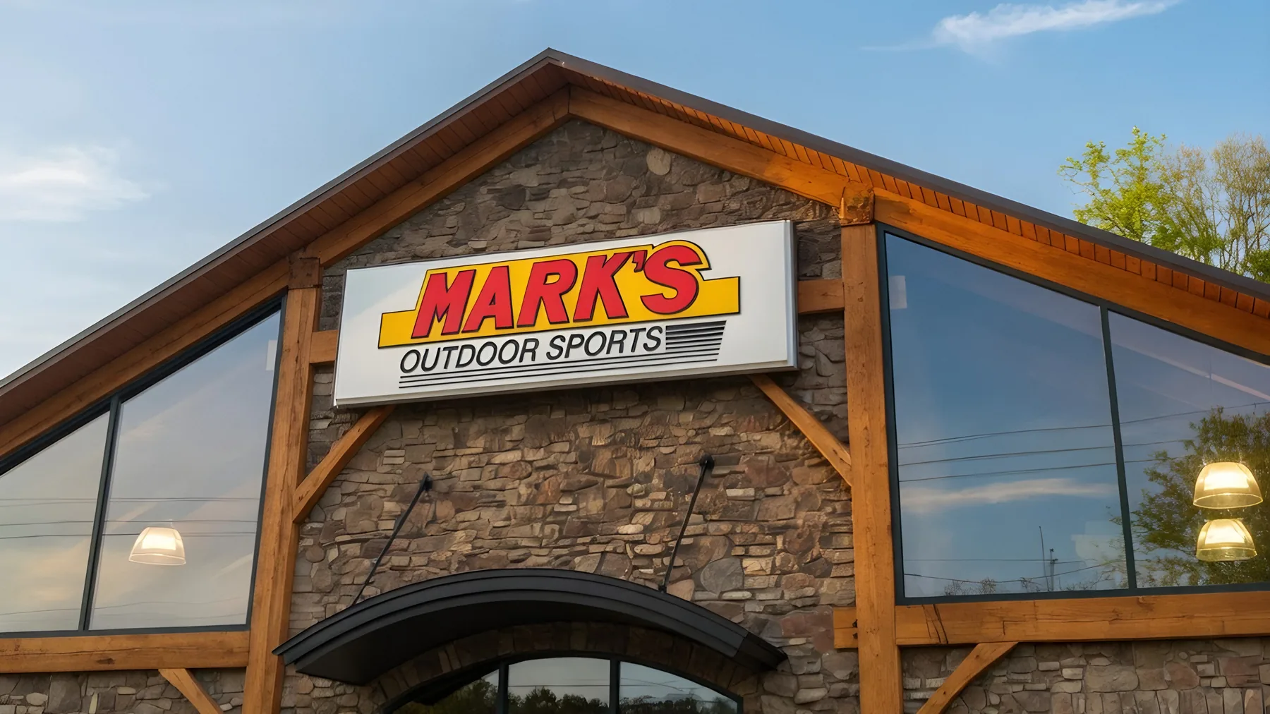 The Mark’s Outdoor Sports sign over the storefront under a blue sky