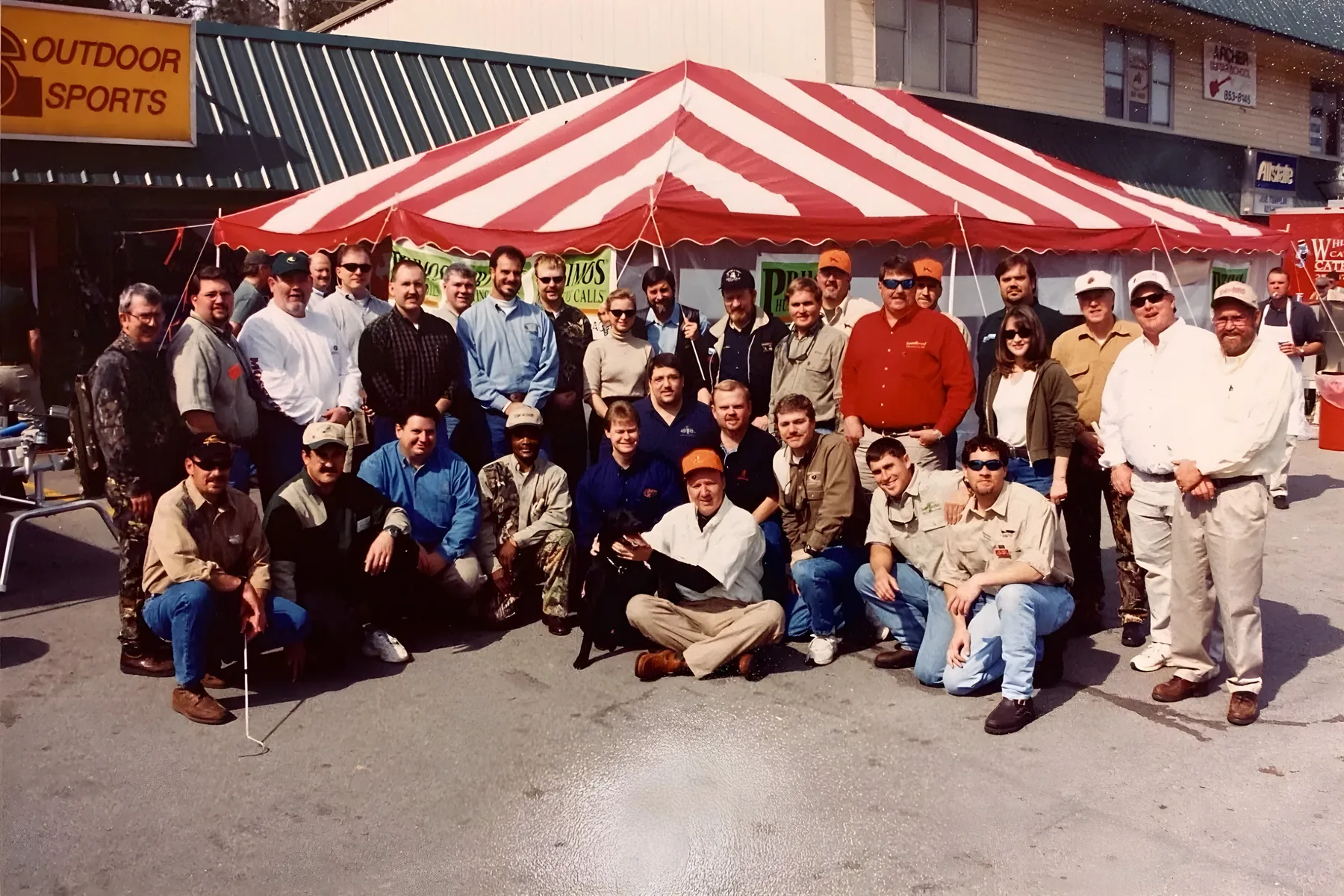 The Mark’s Outdoor Sports team gathered under a striped tent outside the store