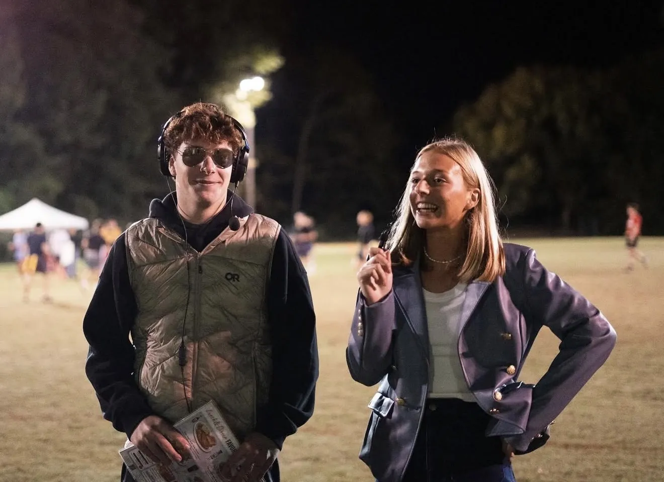 Event hosts on the field during a Samford GameDay night